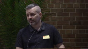 Johan Baumeister preaching at Nativity Lutheran Church with brick background