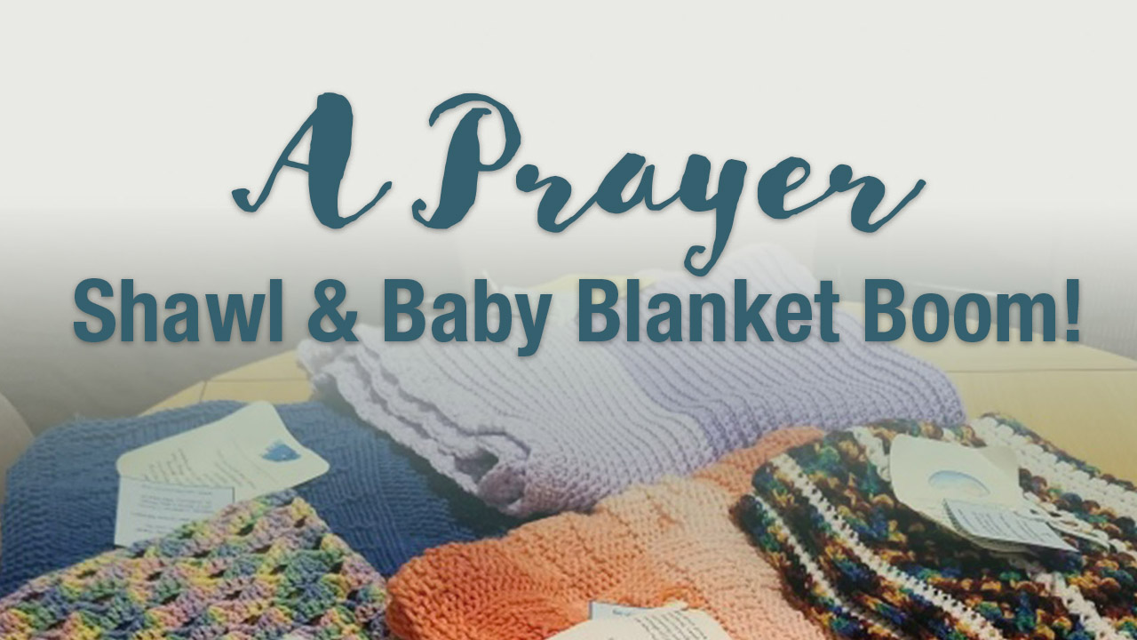 A Prayer Shawl & Baby Blanket Boom with a background of knit shawls and blankets